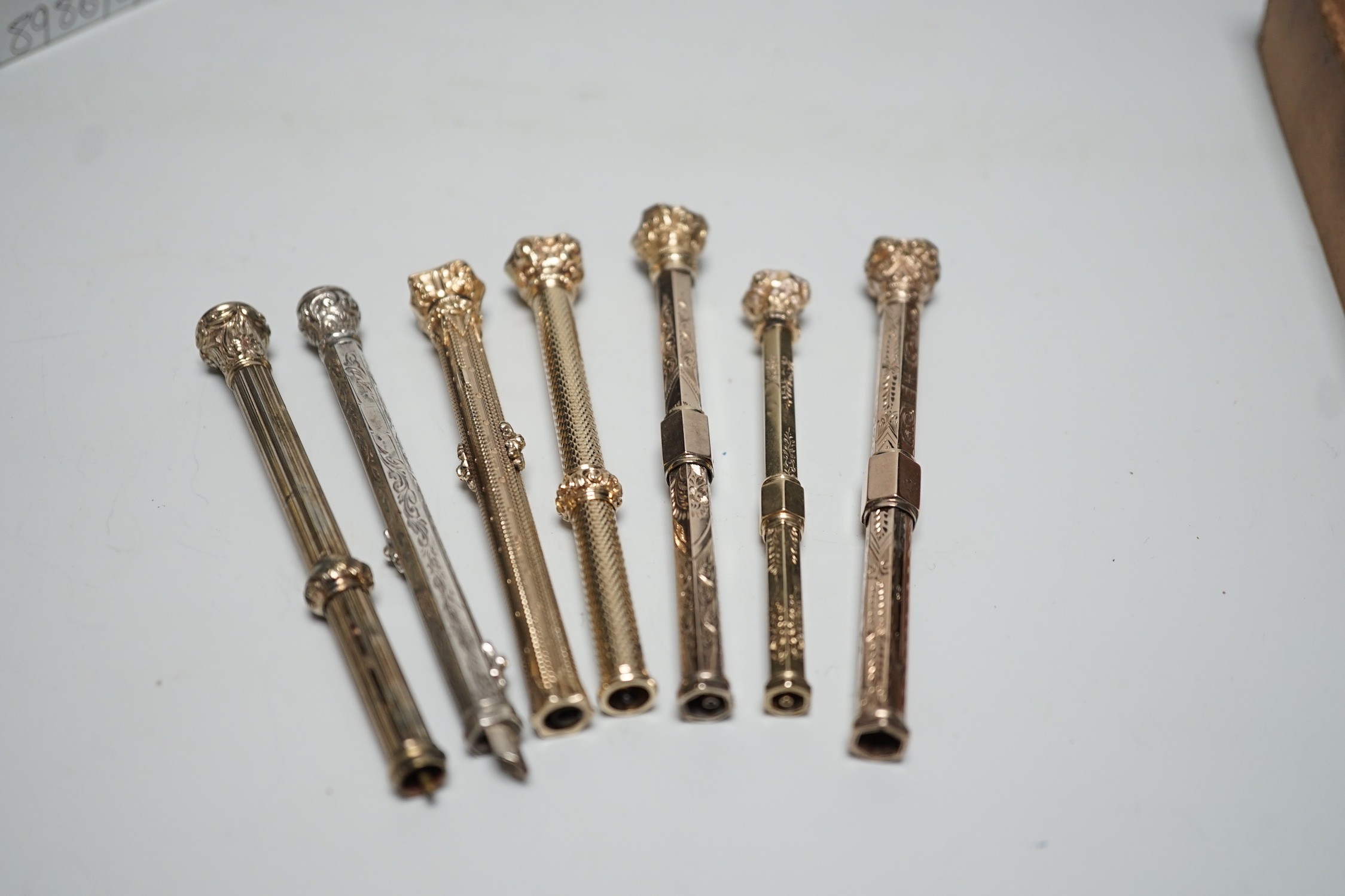 Seven assorted Victorian yellow metal overlaid or gold plated propelling pencils
